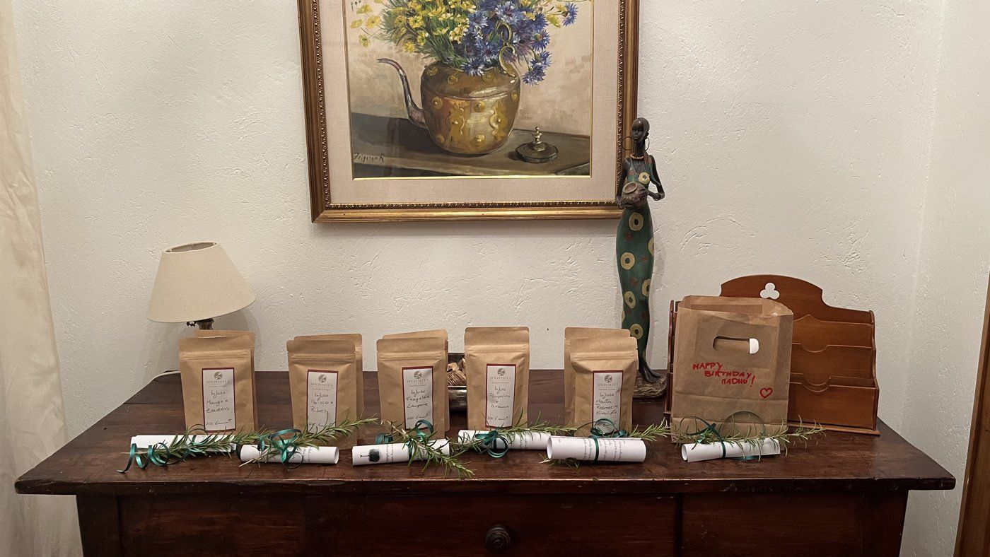 Handwritten welcome notes and rosemary sprigs on a wooden table